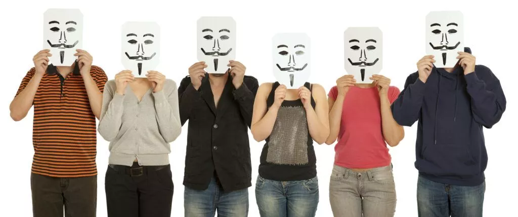 Anonymous hackers - six people holding masks over faces